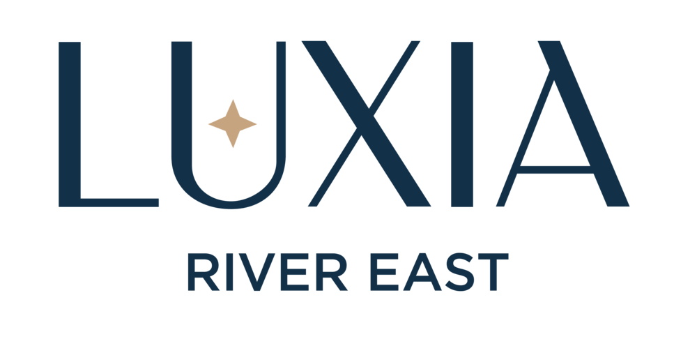 A logo with the word "LUXIA" in large letters and "RIVER EAST" in smaller letters below it.